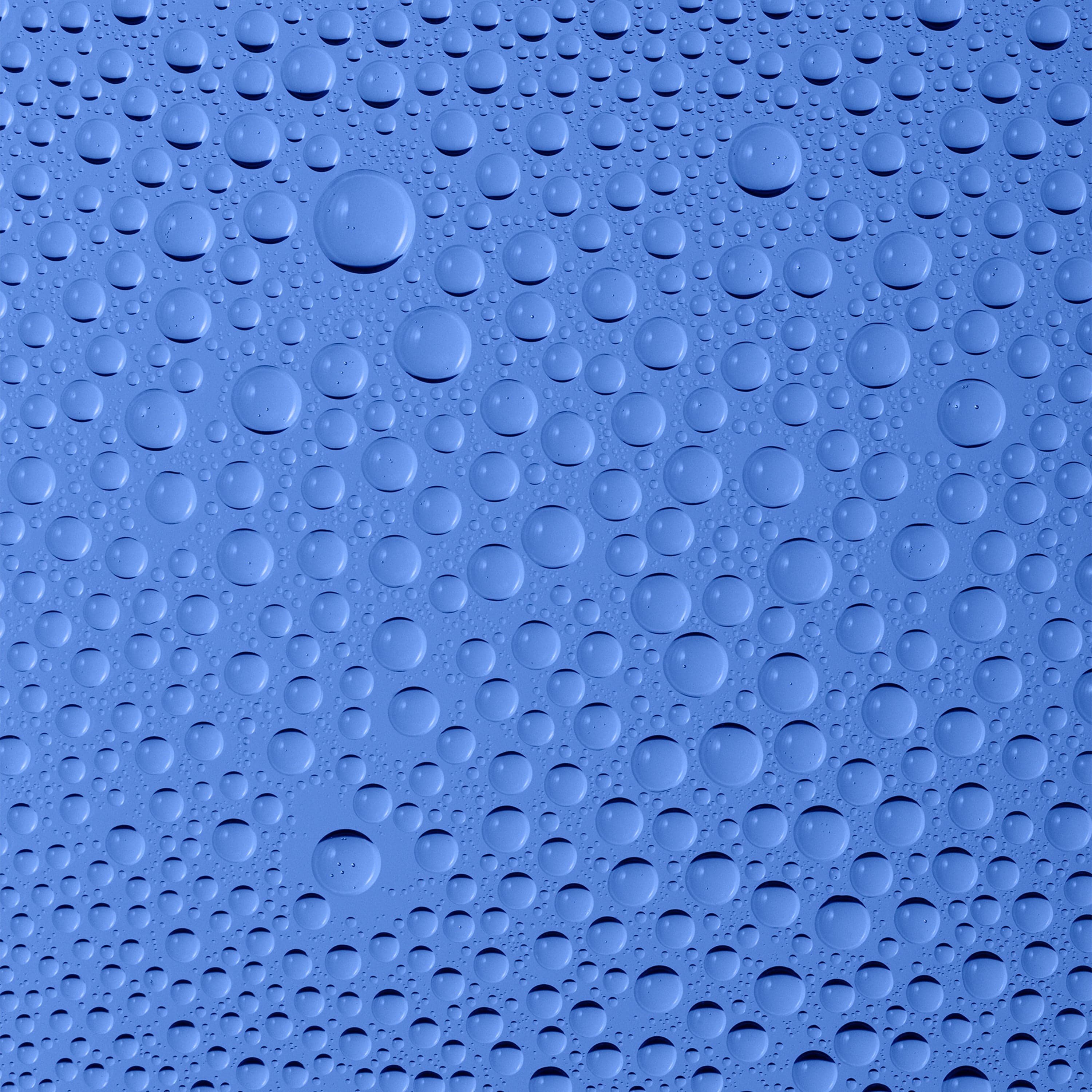 Water droplets on a smooth blue surface.