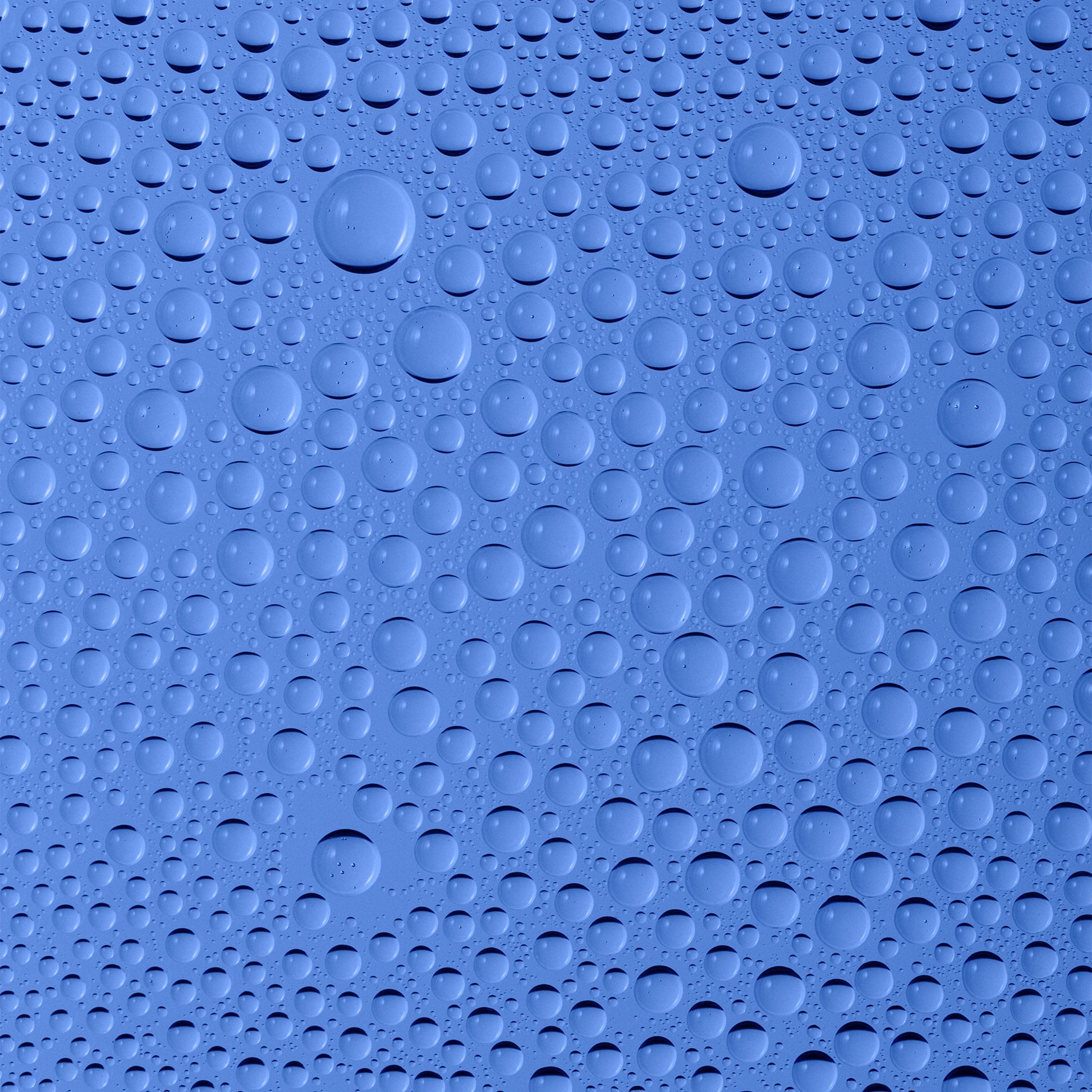 Water droplets on a smooth blue surface.