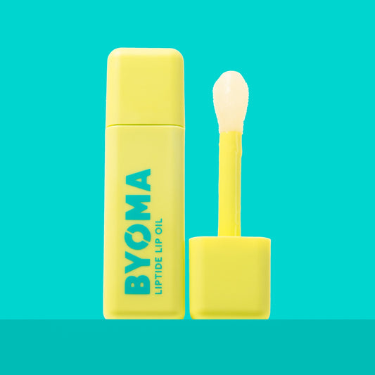 A BYOMA Liptide Lip Oil bottle with its applicator wand removed.