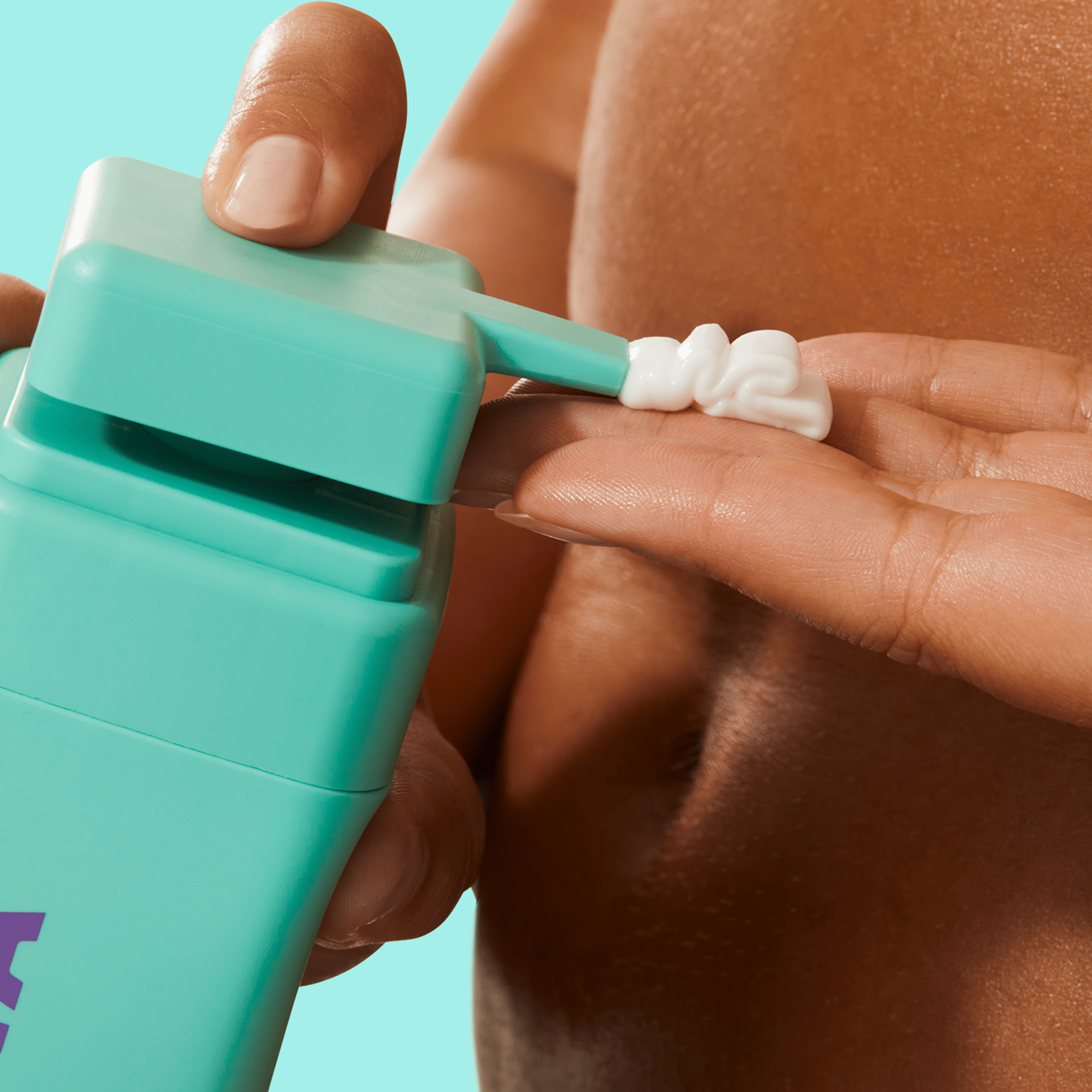 Byoma body lotion dispensed from a teal bottle onto fingers.