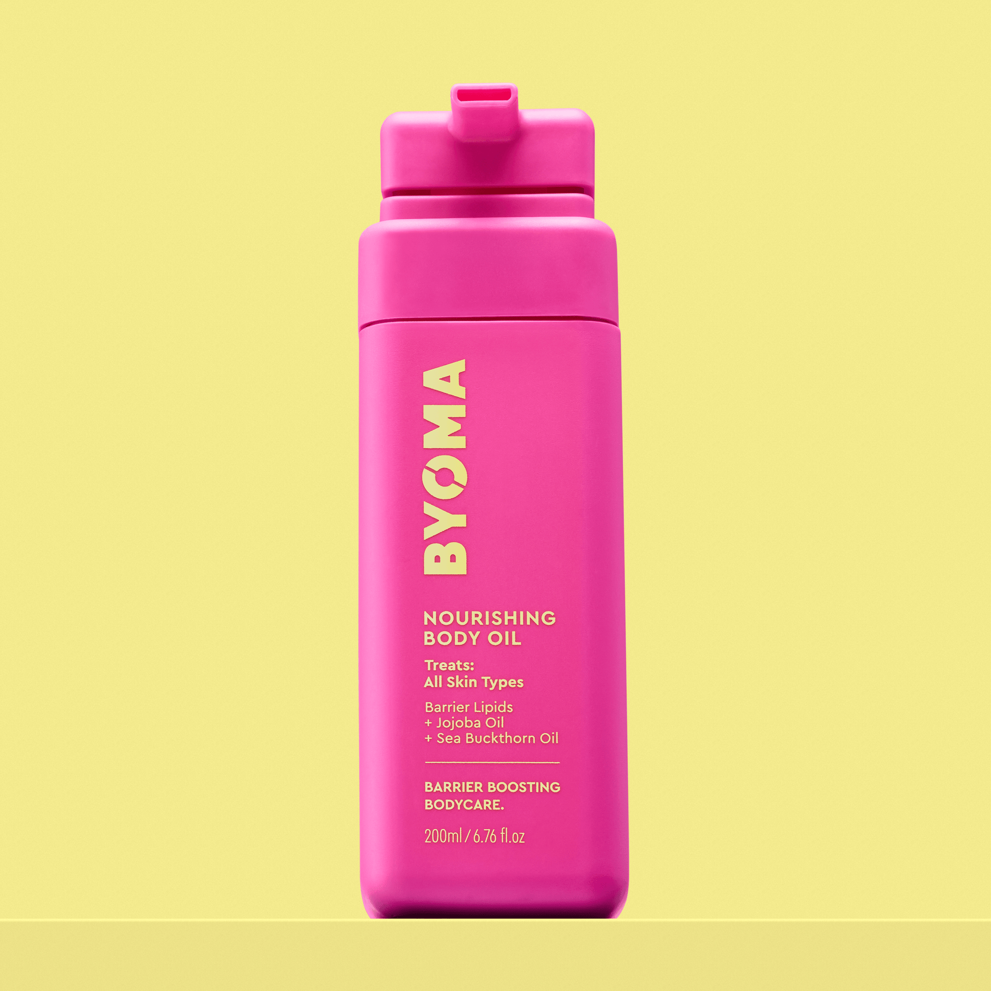 Byoma Nourishing Body Oil in a bright pink bottle.