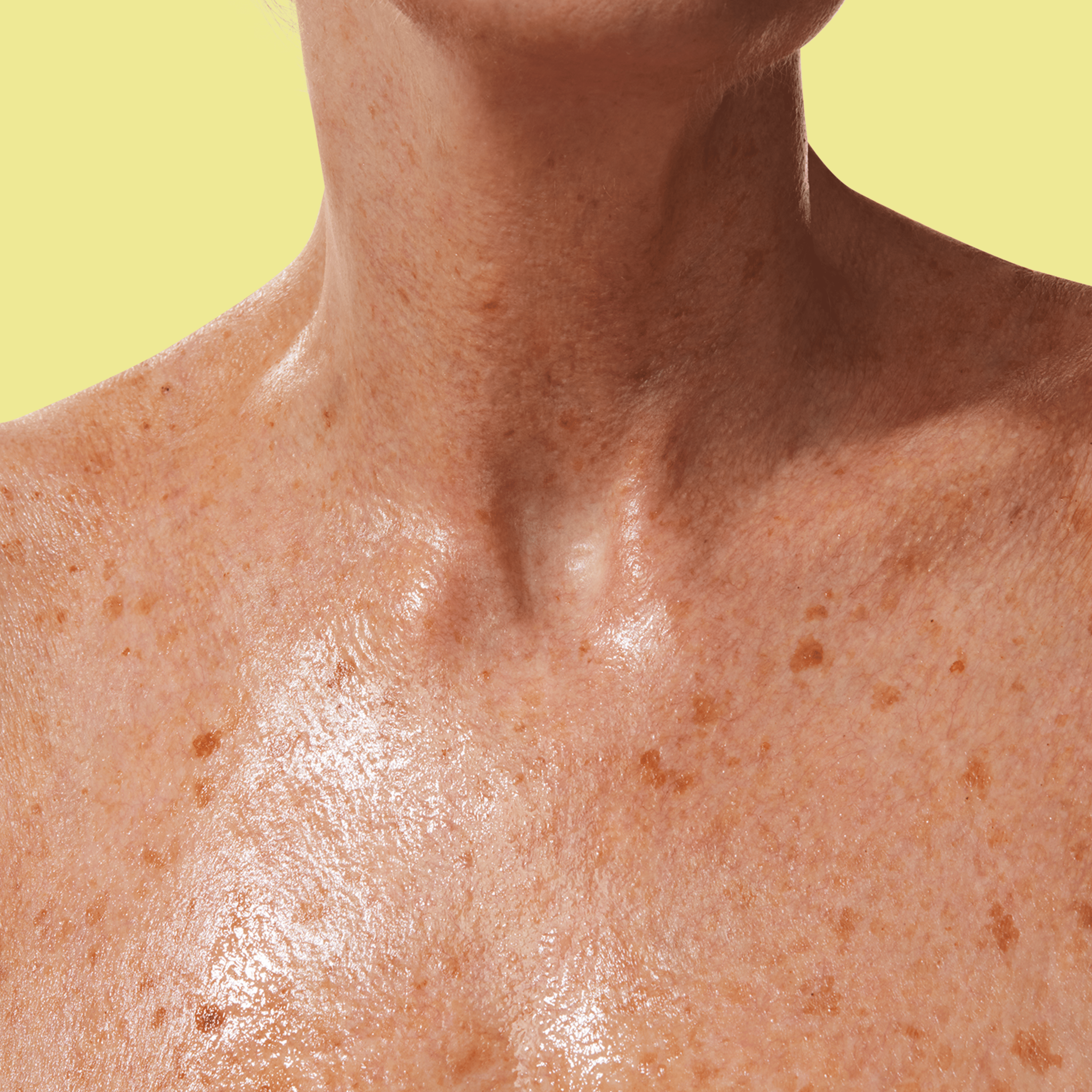 A close-up of moisturised skin on the neck and upper chest.