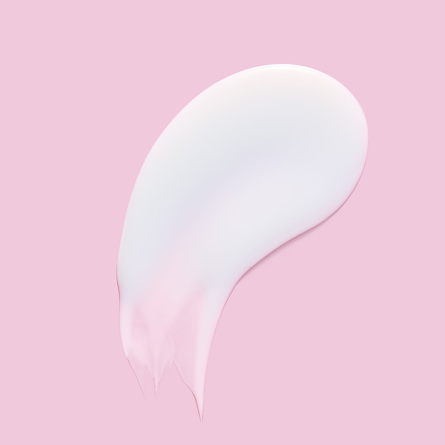 Thick white skincare product against a pink background.