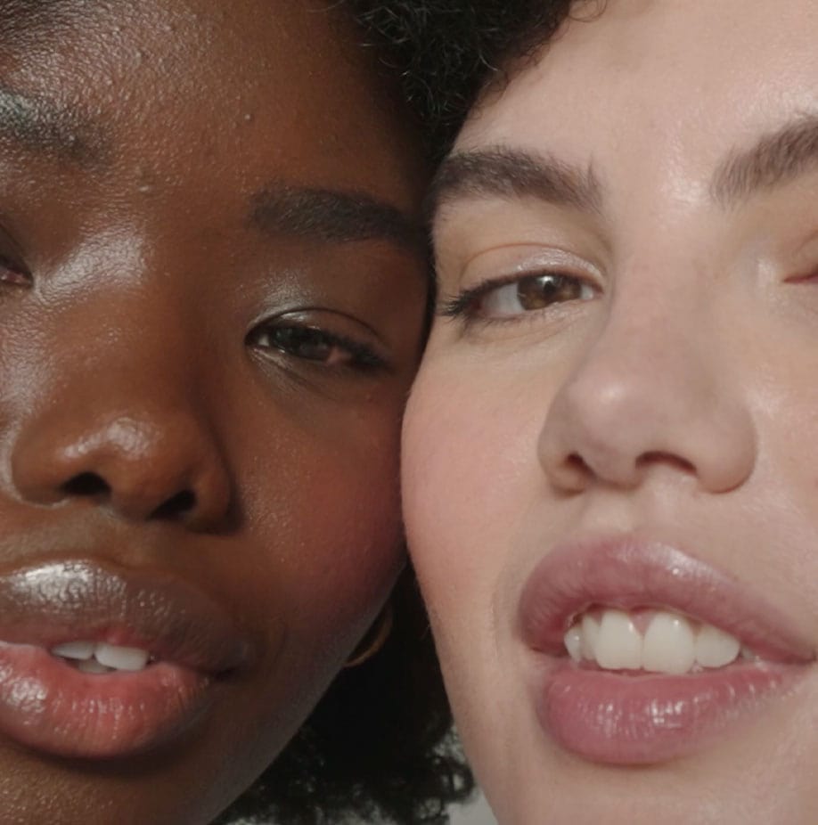 Close-up of two women with glowing, hydrated skin, highlighting skincare results.