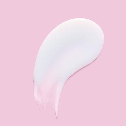 Thick white skincare product against a pink background.
