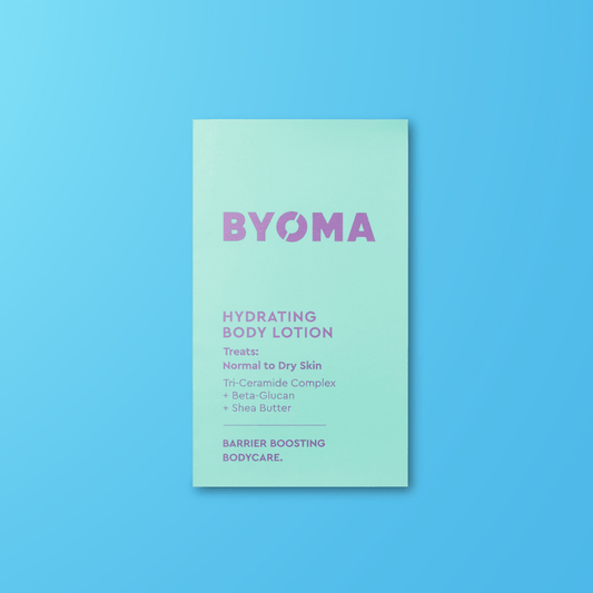 BYOMA hydrating body lotion sample on a blue background
