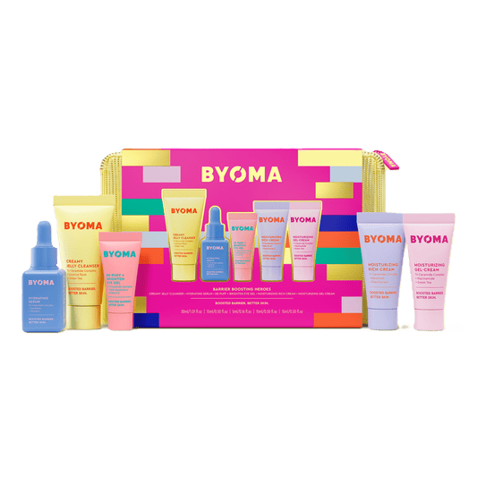 BYOMA Barrier Boosting Heroes skincare set – eight mini skincare products arranged in front of vibrant pink and gold pouch.